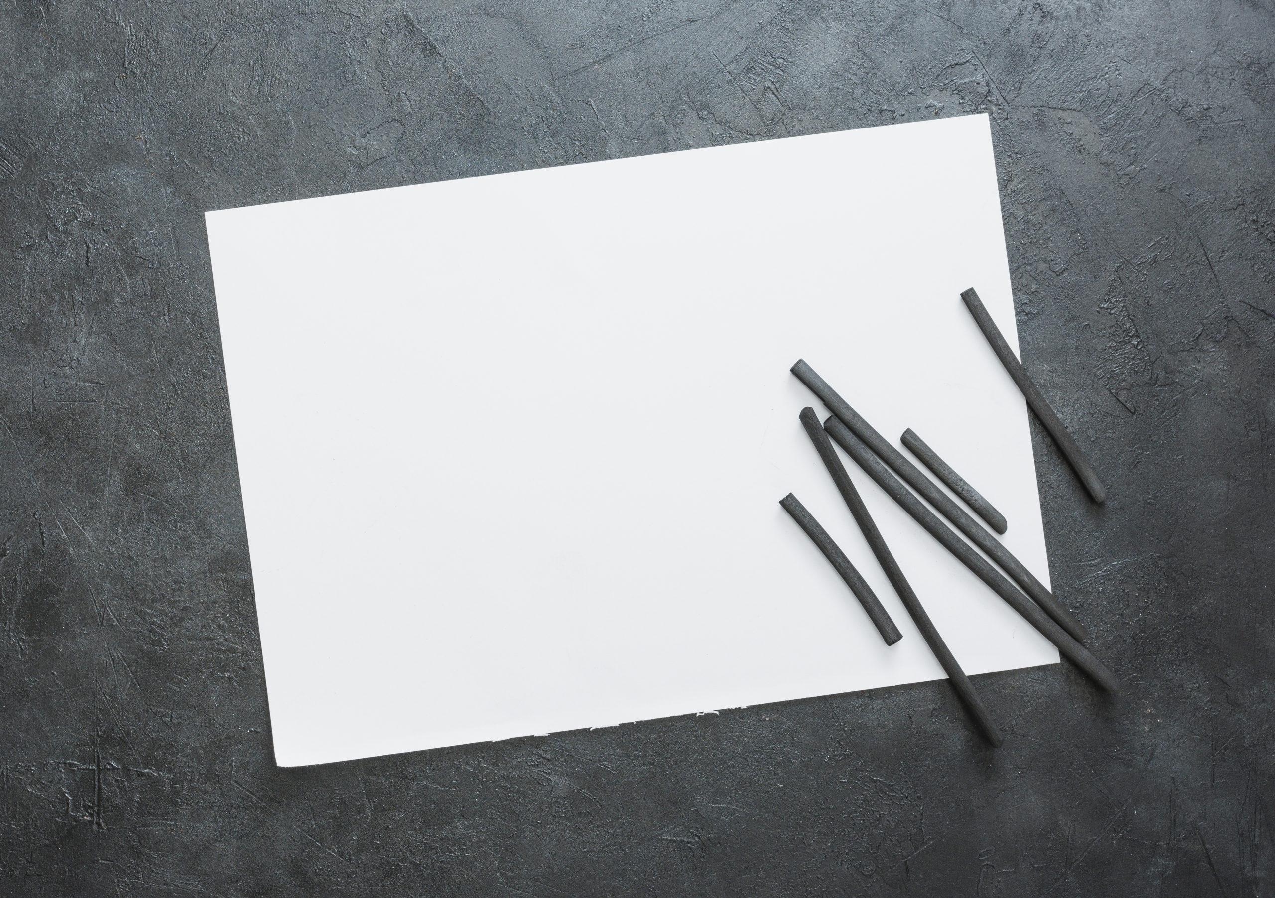 top-view-blank-white-sheet-natural-hardwood-charcoal-stick